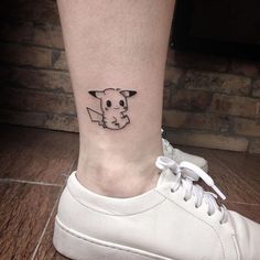 a small tattoo on the ankle of a woman's foot, depicting a pikachu