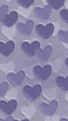 purple hearts are arranged in the shape of heart shapes on a gray background with white dots