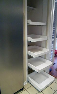 an open refrigerator with shelves on the side