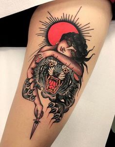 a woman with a tattoo on her leg holding a tiger's head and knife