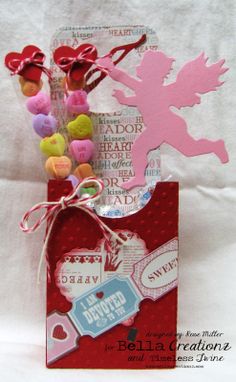 a valentine's day card with candy in a bag and hearts on the tag