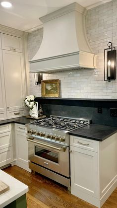 a stove top oven sitting inside of a kitchen