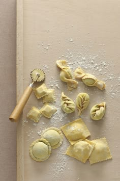 some ravioli on a cutting board with a rolling pin