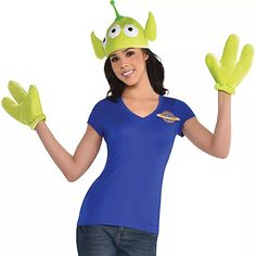 a woman in a blue shirt and green gloves is holding up her hands to the side