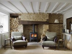 a living room with two chairs and a fire place