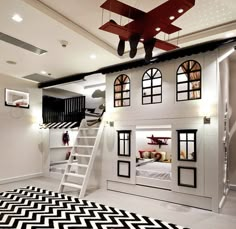 a child's bedroom with a loft bed and stairs leading to the upper level