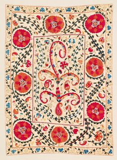 an embroidered square with red flowers and leaves on the border, surrounded by other floral designs