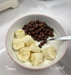 a bowl filled with cereal and bananas on top of a table