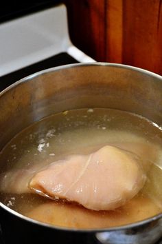 a metal pan filled with food on top of a stove