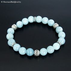 "❖ AQUAMARINE: Natural 8mm gemstone ❖ ♥ Cleansing ♥ Meditation ♥ Serenity ♥ Peace ♥ Prophecy ♥ Inspiration ♥ Tranquility ♥ Inner power strength ♥ Soothing ♥ Calming ♥ Safe travel on water ❖ SPACERS & SILVER BEADS : Antique pewter charms made in USA. ❖ Durable Elastic Stretch Cord. ❖ The gemstones are natural, so you may see some variations. ❖ Your purchase will arrive attractively packaged and ready to give. ❖ Size ❖ Women Small: Fits 5.5\" - 6\" Women Medium: Fits 6\" - 6.5\" Women Large: F Spiritual Light Blue Jewelry With 8mm Beads, Spiritual Aquamarine Round Beads Jewelry, Elegant Light Blue Jewelry With 8mm Beads, Blue Aquamarine 8mm Beads Jewelry, Elegant Blue Amazonite Beaded Bracelets, Elegant Blue Amazonite Bracelets, Elegant Blue Amazonite Bracelet, Blue Amazonite Beaded Jewelry, Elegant Aquamarine Beaded Bracelets