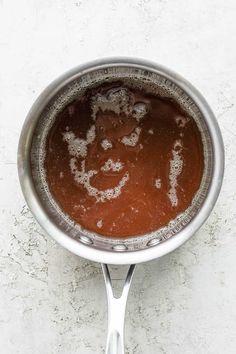 a saucepan with some brown liquid in it