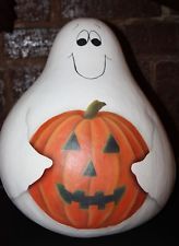 a halloween pumpkin with a ghost face painted on it