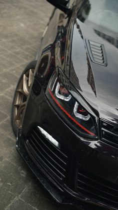 the front end of a black sports car