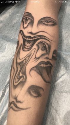 a person with a tattoo on their arm and the image of an evil face is shown