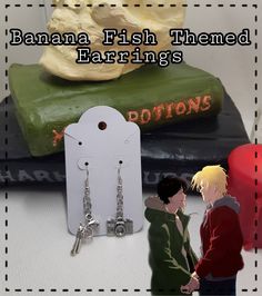 there are two people standing next to each other with the caption banana fish themed earrings