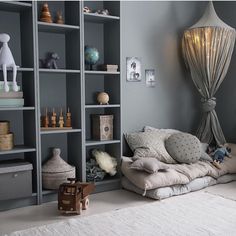 a living room filled with lots of bookshelves next to a white rug on top of a hard wood floor