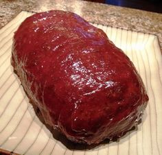 a large piece of meat sitting on top of a white plate