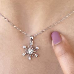 ✥ A gorgeous Christmas present that perfectly encapsulates the charm of the season is this round-cut unique snowflake pendant. The elaborate snowflake design, which showcases a beautifully glittering round cut diamond in the middle, is a representation of uniqueness and the beauty of winter. This pendant, which was expertly crafted from premium materials, is the ideal present for a particular someone. This snowflake necklace is a classic holiday gem that will add elegance and delight to any occasion, whether you're looking for unusual Christmas gifts for women or just want to add some festive shine to your jewelry collection.✦ Stone Details:✧ Stone Type: Moissanite✧ Stone Cut: Round Cut✧ Stone Total Weight: 0.25CT ✧ Color: DEF✧ Clarity: VVS✧ Make: Hight Quality Craftmanship ✦ Metal Details Sparkling Snowflake Jewelry In Sterling Silver, Snowflake Shaped Sparkling Sterling Silver Jewelry, White Gold Snowflake Necklace For Anniversary, Sparkling Snowflake Sterling Silver Jewelry, Sparkling Silver Christmas Jewelry, Diamond White Snowflake Jewelry For Anniversary, Diamond White Cubic Zirconia Snowflake Jewelry, Anniversary White Gold Snowflake Jewelry, Fine Jewelry Snowflake Cubic Zirconia