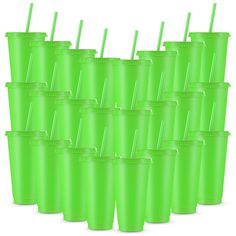 a bunch of green cups with straws in them