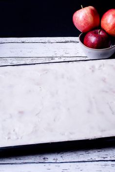 some apples are in a bowl on a table