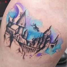 a tattoo on the leg of a person with a castle in the sky behind it