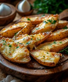 baked potato wedges with cheese and parsley on a wooden platter