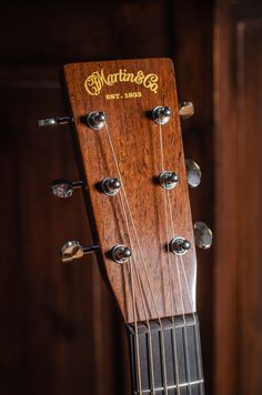 an acoustic guitar with the heads and strings showing