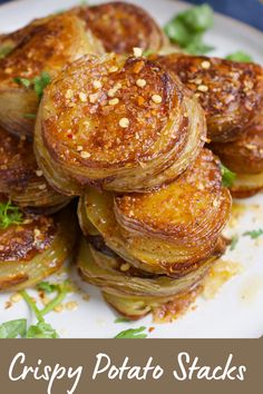 crispy potato stacks on a white plate