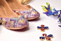 Candor - Multicolor Lilac Designer Punjabi jutti for Ladies B Anu Designs have launched their ethnic Indian footwear collection and you're going to fall for it. These lilac multicolor designer juttis are goals for any lady out there looking for some unique ethnic Indian shoes that are comfortable and stunning at the same time. The lilac fabric base has rows of pastel, pretty sequins in shades of pink, sage, lime green, lilac and blue in a geometric pattern giving this jutti the absolute glamour Multicolor Flat Shoes For Festive Occasions, Multicolor Flats For Festivals, Multicolor Party Flats, Summer Festive Multicolor Flats, Punjabi Juti, Multicolor Slip-on Flats For Festive Season, Festive Multicolor Flats With Gota Work, Festive Multicolor Gota Work Flats, Purple Juttis