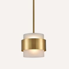 a gold and white light hanging from a ceiling fixture