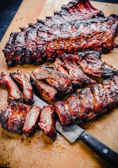 the steaks are ready to be grilled on the cutting board with a knife