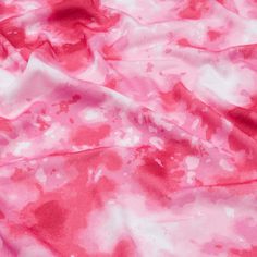 the pink and white fabric has been dyed with watercolors on it's surface