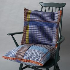 a chair with a colorful pillow on it