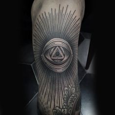 a man's leg with an all seeing eye tattoo on it