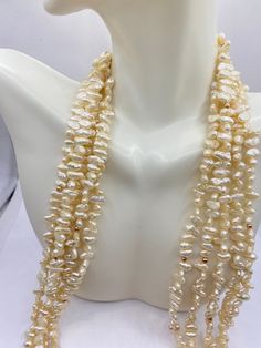 This is a lovely 20inch baroque pearl choker necklace, with 14k gold beads  Pearl, the birthstone of June, is often the gemstone associated with the third wedding anniversary.  A pearl is composed of calcium carbonate formed in the mantle of a shelled mollusk, such as an oyster.  A pearl is created as layers of nacre, otherwise known as mother of pearl, adhere over time. The surface of a genuine pearl will generally be pulverent, a gentle roughness to the touch revealing this process. The pearl gem inspires introspection and cultivates wisdom as we seek connection to ourselves and to the universe.  Pearl is known for restoring and invigorating the Sacral, Heart and Crown Chakras.  The pearl signifies wisdom, experience and integrity. Pearls are extremely soft and fragile, measuring 2.6-4.6 Gold Baroque Pearl Necklace With High Luster, Baroque High Luster Gold Pearl Necklace, Gold Baroque Single Strand Necklace, Baroque Pearl Jewelry For Anniversary, Gold Pear-shaped Single Strand Pearl Necklace, Gold Pear-shaped Pearl Drop Necklace, Gold Pearl Beaded Necklaces For Anniversary, Baroque Necklace With High Luster As Gift, Baroque Necklace With High Luster For Gift