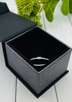 This beautiful and dainty ring is made of solid 925 sterling silver and has a center emerald cut 2x4mm moissanite stone. The ashes are set behind the stone. You may be able to see the ashes through the stone depending on the ash color. Mailing instructions for your ashes can be found on the main page of the website. Please mail them to me ASAP. You can order a prepaid shipping kit if you would like, but it is not required. Sterling Silver Diamond Ring For Gift, Fine Jewelry Sterling Silver Diamond Ring Gift, Minimalist Stackable Emerald Cut White Gold Rings, Minimalist Stackable White Gold Emerald Cut Rings, Minimalist White Gold Stackable Rings With Emerald Cut, Minimalist Silver Diamond Ring Gift, Minimalist Sterling Silver Birthstone Ring With Single Diamond, Minimalist Sterling Silver Diamond Ring For Anniversary, Elegant Sterling Silver Stackable Initial Ring