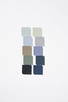 several different shades of blue and gray on a white background with one color swatch in the middle