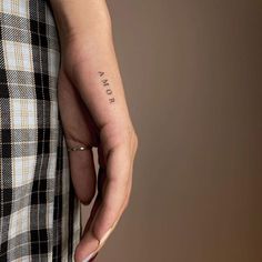 a woman's hand with a small tattoo on her left wrist that says, i am not okay