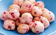 a blue plate filled with cranberry cookies on top of a table