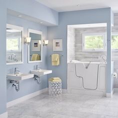 a bathroom with blue walls and white fixtures