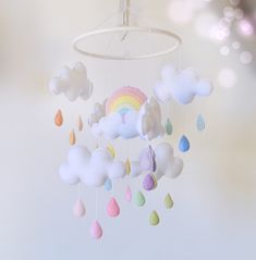 a mobile with clouds and rainbows hanging from it