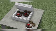 two chocolate cupcakes with reindeer noses in a box on the ground next to each other