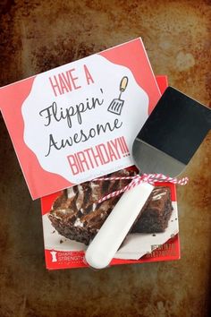 a piece of cake and a knife on top of a card that says have a flippin'awesome birthday