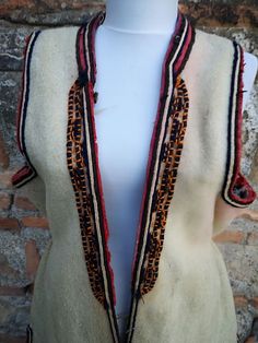 This is a a long vest, also known as 'klashenik' and also as 'resacka' part of the women's ethnic costume from the south western part of Macedonia, Struski Drimkol. This vest was made in the second half of XIX century and is really rare piece of the ethnic costume from this region. The vest has a few damages visible on the photos, a hole at the back side, few damages on the embroidery on the sleeves and a discoloring from washing on some places and that's the reason the price is much lower than Handmade Folk Style Vest For Festivals, Handmade Folk Vest For Festivals, Traditional Sleeveless Vest Outerwear, Folk Style Fitted Festival Vest, Traditional Fitted Vest For Fall, Traditional Sleeveless Winter Vest, Traditional Fitted Fall Vest, Traditional Ceremonial Sleeveless Vest, Vest Handmade