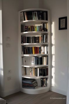 a white book shelf filled with lots of books