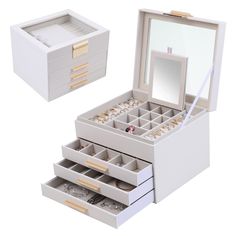 an open jewelry box with three drawers and a mirror on the top one is empty