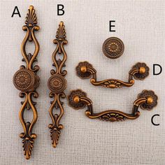 an assortment of decorative hardware on a white surface