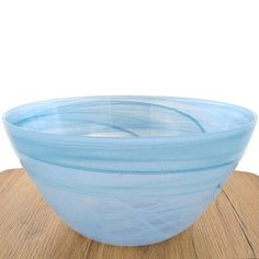 a blue glass bowl sitting on top of a wooden table