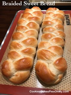 two loaves of bread sitting on top of a baking sheet with the words braided sweet bread