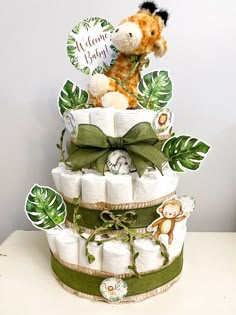 a diaper cake made to look like a giraffe on top of it